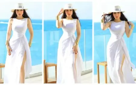 صور- ياسمين عز بفستان جريء بفتحة ساق على البحر في مراسي